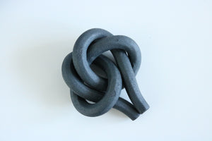 Aged iron true lover's knot.
