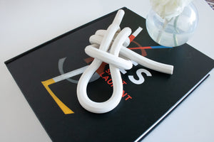 Bare, porcelain double dragon loop knot